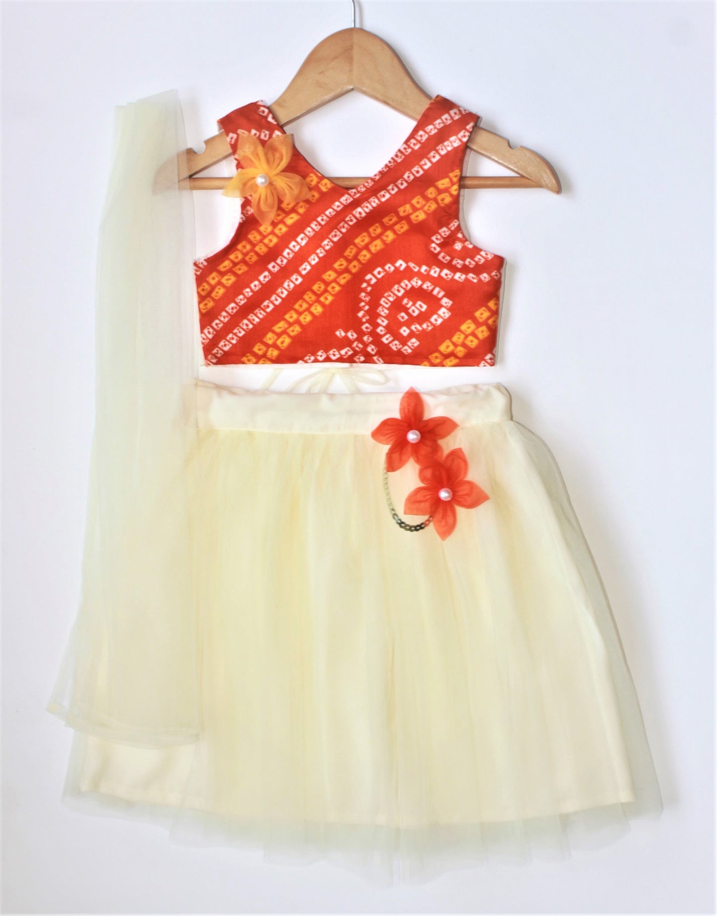 Many frocks & Sleeveless Bandhani Choli With Flared Lehenga & Dupatta Set - Orange & Cream